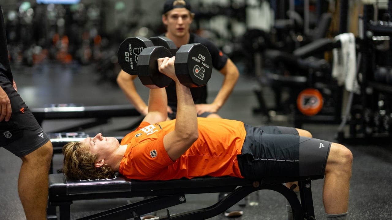 Philadelphia Flyers forward Alex Bump working out in weight room. 