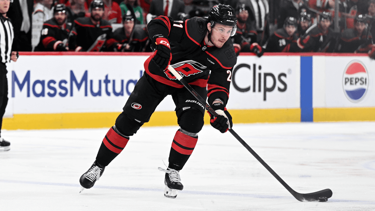 RALEIGH, NC - MAY 23: Defenseman Alexander Nikishin (21) of the Carolina Hurricanes passes the puck while walking the blue line during game two of the NHL Stanley Cup Playoffs Eastern Conference Final between the Montreal Canadiens and the Carolina Hurricanes on May 23, 2026 at Lenovo Center in Raleigh, North Carolina.