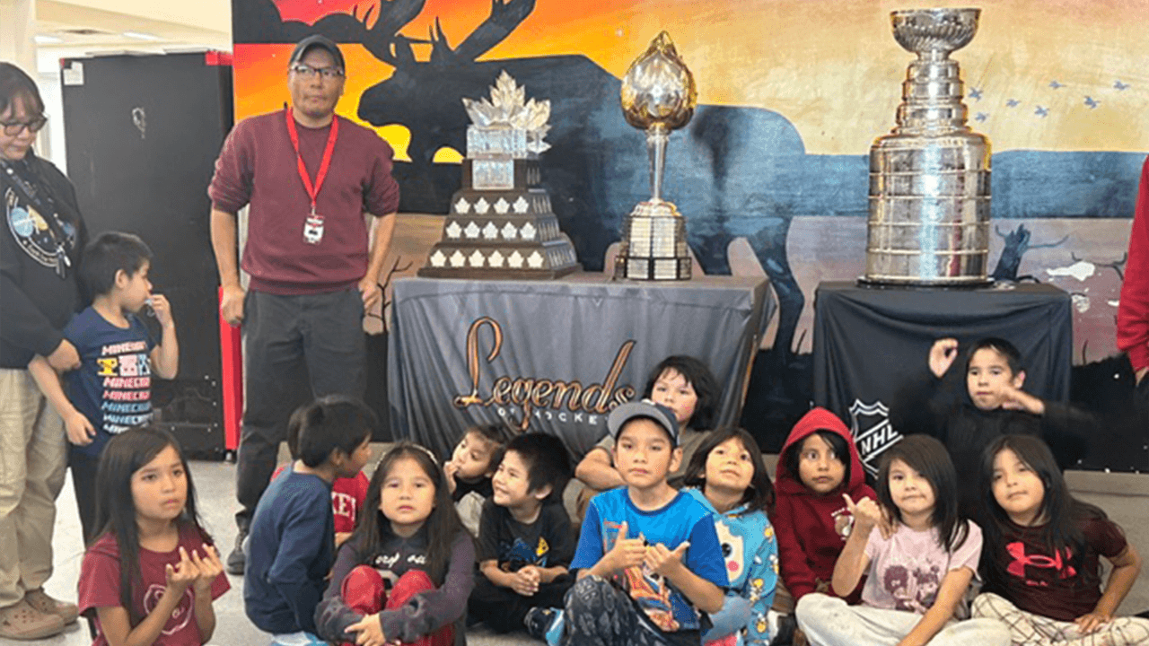 Pikangikum First Nation poses with Stanley Cup, Hart, Conn Smythe trophies
