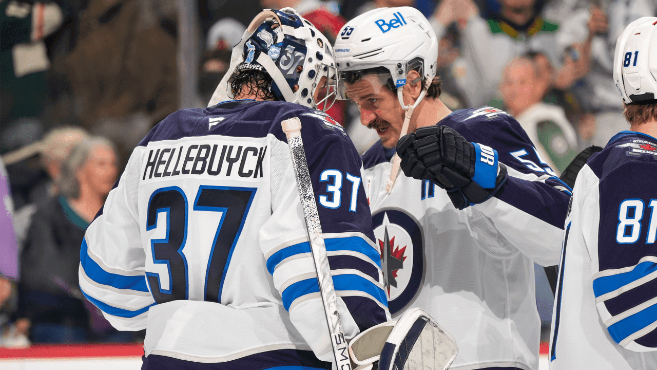 SAINT PAUL, MN - JANUARY 15: Mark Scheifele #55 and Connor Hellebuyck #37 of the Winnipeg Jets celebrate after defeating the Minnesota Wild at Grand Casino Arena on January 15, 2026 in Saint Paul, Minnesota.