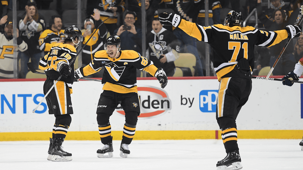 PITTSBURGH, PA - JANUARY 24: Kris Letang #58 of the Pittsburgh Penguins celebrates with teammates, Sidney Crosby #87 and Evgeni Malkin #71, after scoring the game winning goal in overtime to give the Penguins a 7-6 win over the Florida Panthers during the game at PPG PAINTS Arena on January 24, 2023 in Pittsburgh, Pennsylvania.