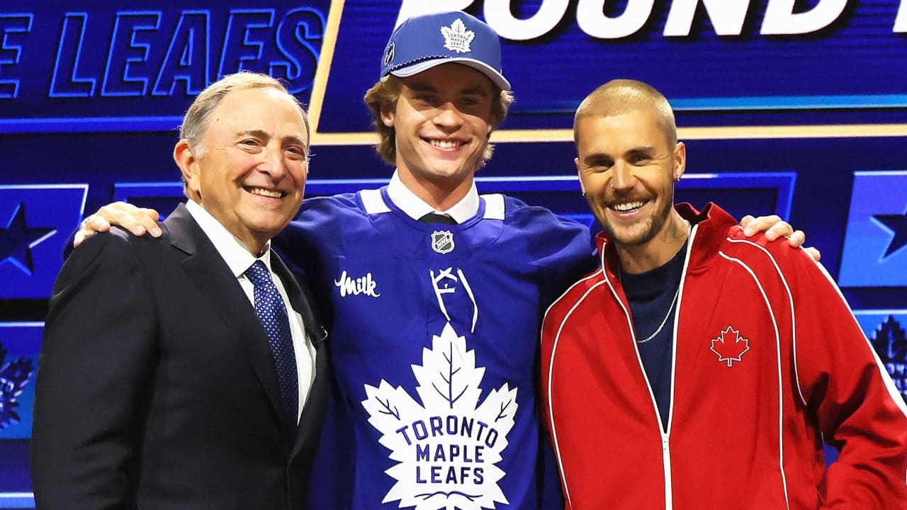 BUFFALO, NEW YORK - JUNE 26: (L-R) NHL Commissioner Gary Bettman looks on as Gavin McKenna of Canada and singer Justin Bieber look on after McKenna was drafted by the Toronto Maple Leafs with the first overall pick during day one of the 2026 NHL Draft on June 26, 2026 in Buffalo, New York. (Photo by Bruce Bennett/Getty Images)