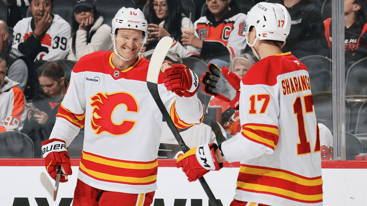 Jonathan Huberdeau #10 of the Calgary Flames celebrates his second period goal against the Philadelphia Flyers with Yegor Sharangovich #17 