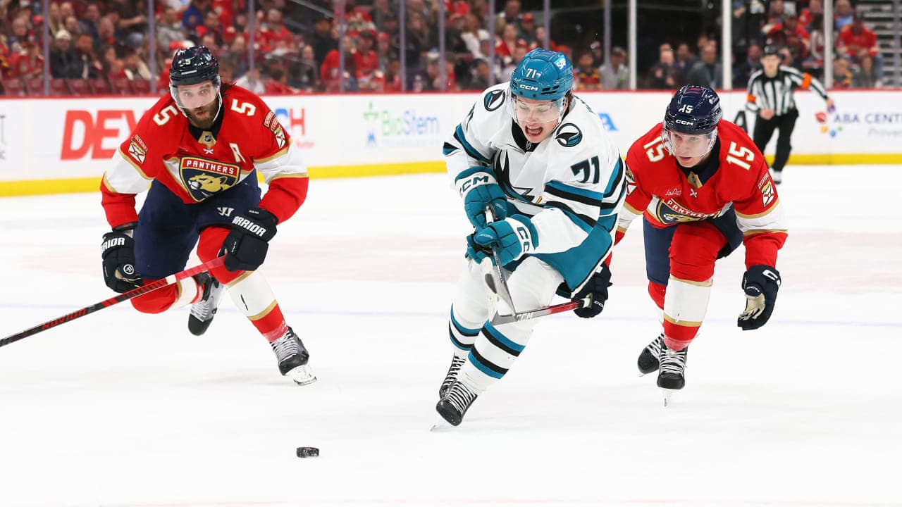 SUNRISE, FLORIDA - JANUARY 19: MacKlin Celebrini #71 of the San Jose Sharks pulls away from Aaron Ekblad #5 and Anton Lundell #15 of the Florida Panthers during the first period at Amerant Bank Arena on January 19, 2026 in Sunrise, Florida. (Photo by Bruce Bennett/Getty Images)