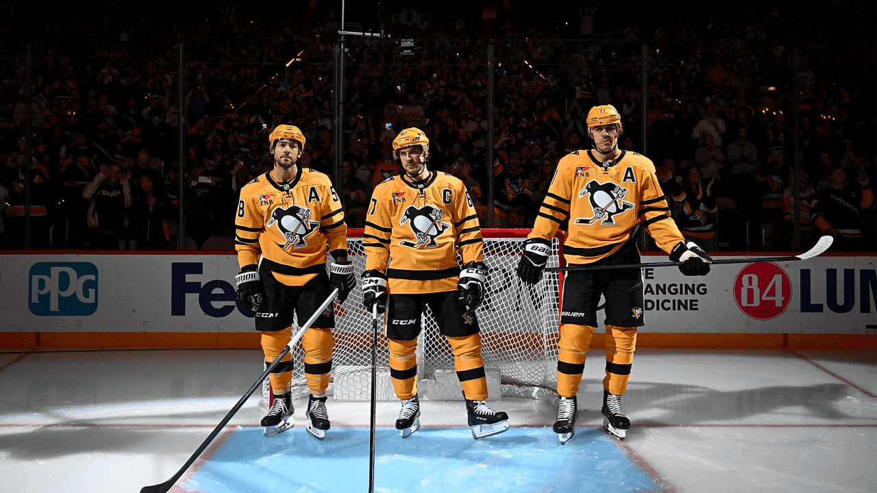PITTSBURGH, PA - OCTOBER 09: Kris Letang #58, Sidney Crosby #87 and Evgeni Malkin #71 of the Pittsburgh Penguins stand during introductions before the game against the New York Islanders at PPG PAINTS Arena on October 9, 2025 in Pittsburgh, Pennsylvania. 