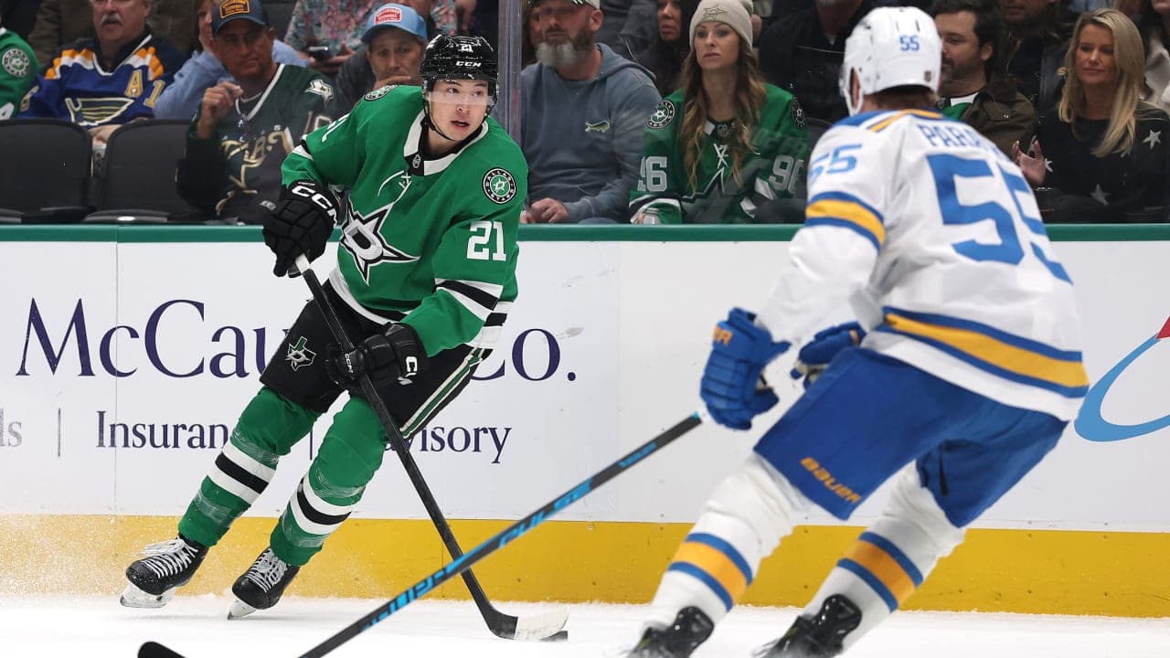 Jason Robertson #21 of the Dallas Stars advances the puck under pressure from Colton Parayko #55 of the St. Louis Blues during the first period at American Airlines Center on January 23, 2026 in Dallas, Texas. 