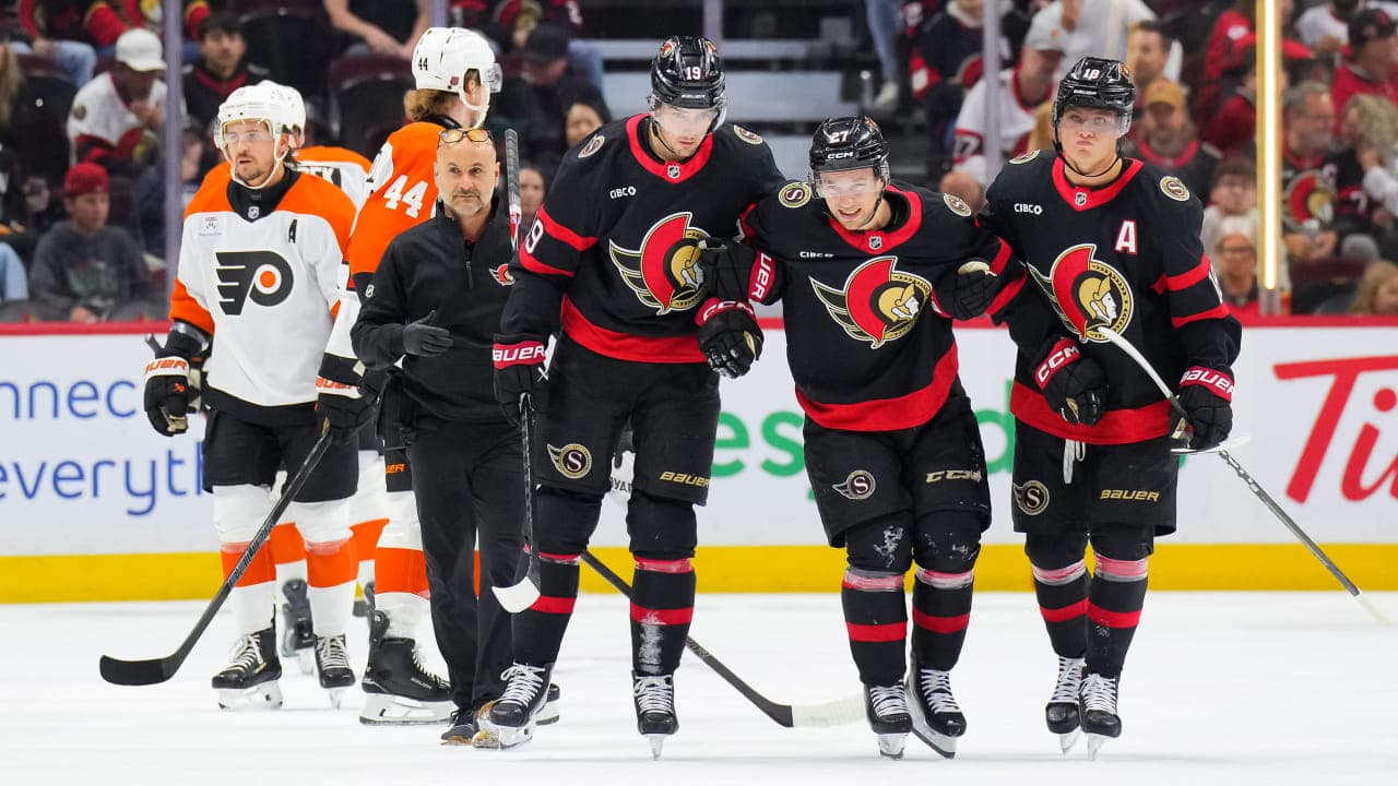 William Eklund #27 of the Ottawa Senators is assisted off the ice by his teammates Drake Batherson #19 and Tim Stützle #18 after an injury in the first period against the Philadelphia Flyers at Canadian Tire Centre on October 08, 2026 in Ottawa, Ontario, Canada. 