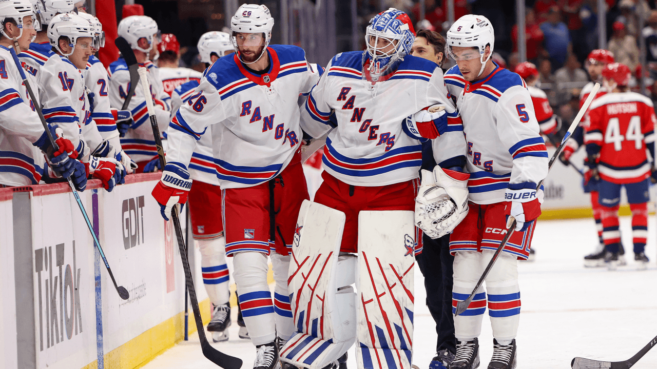 Igor Shesterkin #31 of the New York Rangers is helped off the ice by Marcus Pettersson #26 and Sean Durzi after suffering an injury 