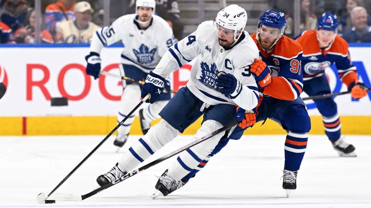 Auston Matthews #34 of the Toronto Maple Leafs shields the puck from Connor McDavid #97 of the Edmonton Oilers during the second period of the game at Rogers Place on February 3, 2026, in Edmonton, Alberta, Canada. 