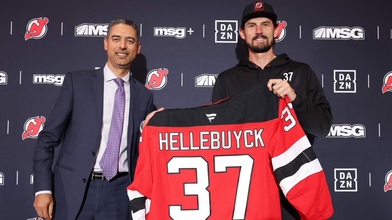 Sunny Mehta and Connor Hellebuyck pose for a photo for the media after being traded to the New Jersey Devils from the Winnipeg Jets at Prudential Center on October 24, 2026 in Newark, New Jersey. 