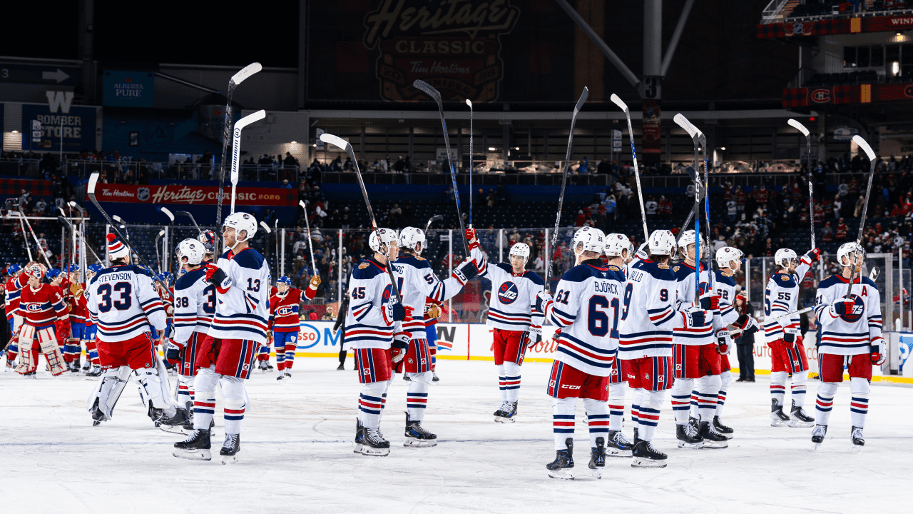 The Winnipeg Jets applaud the fans as a team after the game at the 2026 NHL Heritage Classic 